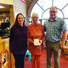 Sara Lancaster, Limon Chamber of Commerce Vice President and James Martin, Limon Chamber President, present Luci Reimer with a silver buckle for her years of dedication to the Limon Chamber of Commerce.
