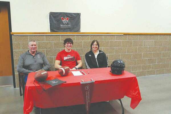 Limon High School senior Ahren Schubarth signed a letter of intent this week to play football for the Western Colorado University Mountaineers in Gunnison.  Ahren plans to study Computer Science(software engineering).  Seated with him are his mother Wendy Schubarth and Coach O’Dwyer.